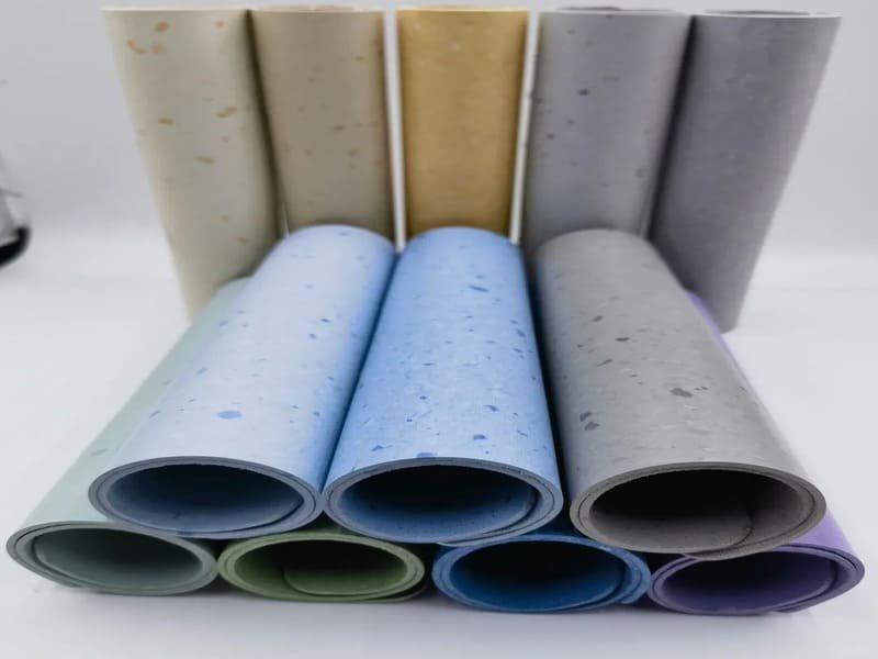Factory worker checking PVC rolls and PP tiles quality